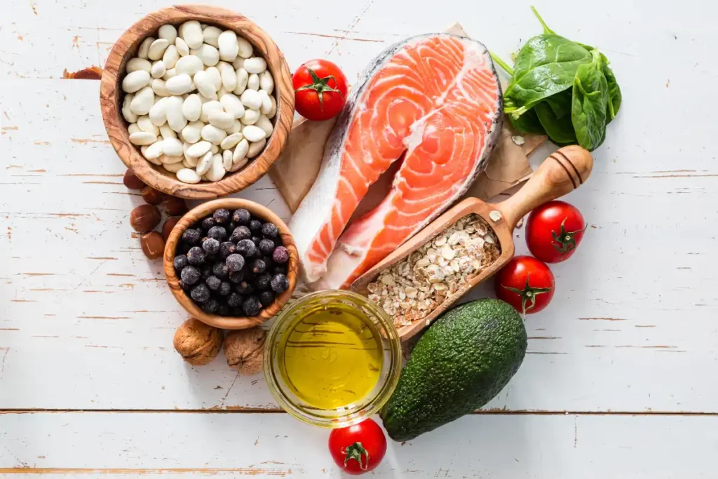 A variety of heart-healthy foods including salmon, leafy greens, nuts, and berries, promoting cardiovascular health.