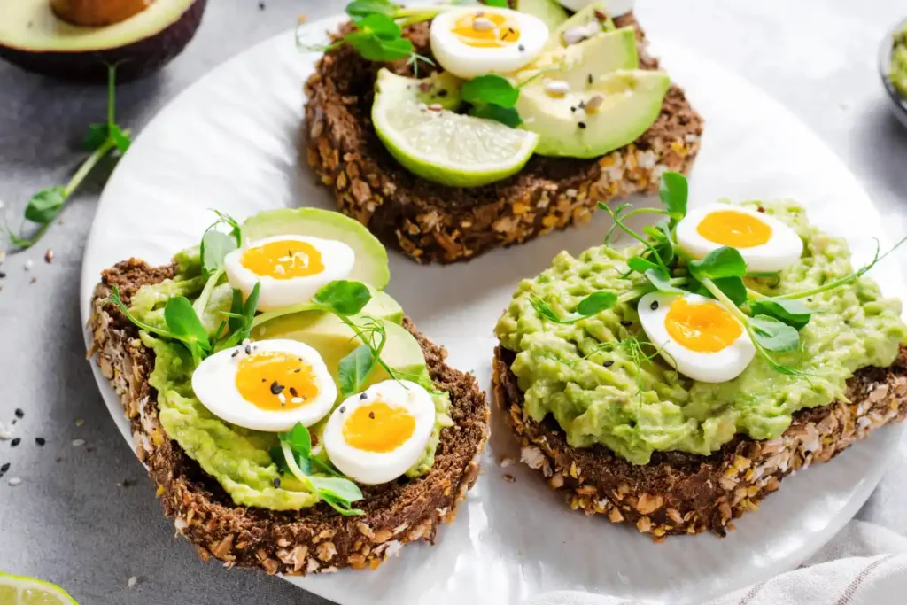 Avocado and quail egg toasts served on whole grain bread, a nutritious and delicious option for a healthy snack or breakfast.
