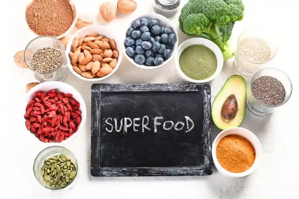 A variety of superfoods, including berries, chia seeds, spices, and more, arranged on a light background to showcase their health benefits.