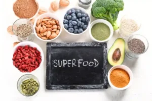 A variety of superfoods, including berries, chia seeds, spices, and more, arranged on a light background to showcase their health benefits.