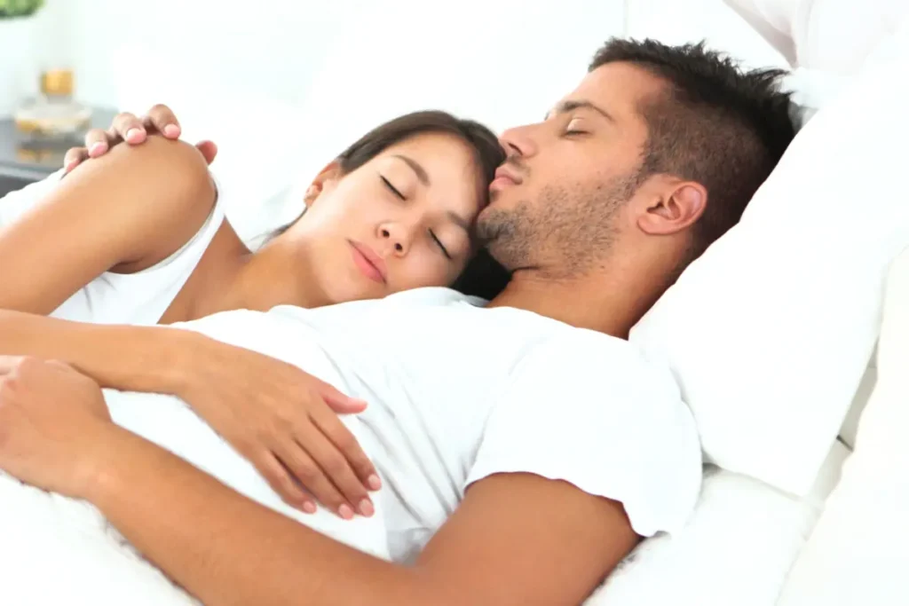 Couple peacefully sleeping at night, enjoying restful sleep.