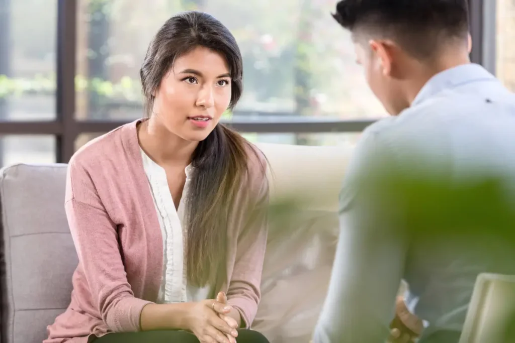 Man receiving therapy from a therapist in a calming and professional setting.