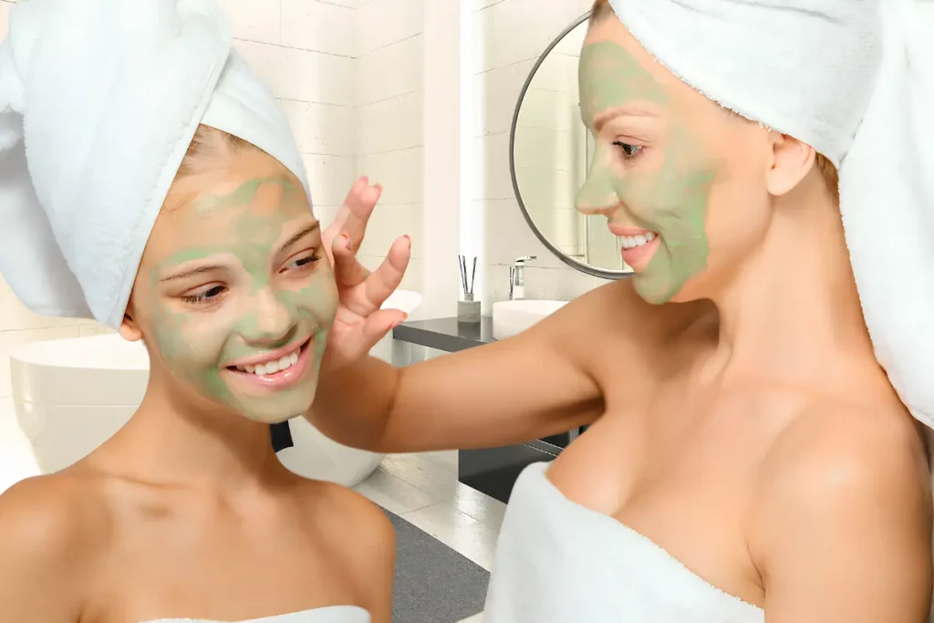 Mother and daughter enjoying a beauty treatment together, applying face masks for skincare and relaxation.
