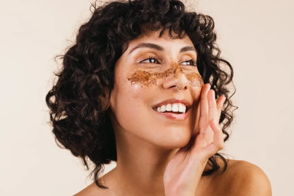 Woman applying an exfoliating skincare treatment, gently removing dead skin cells for a smoother, refreshed complexion.
