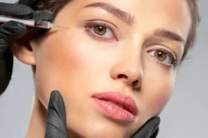 Woman undergoing a botox injection near her eyes for wrinkle reduction.