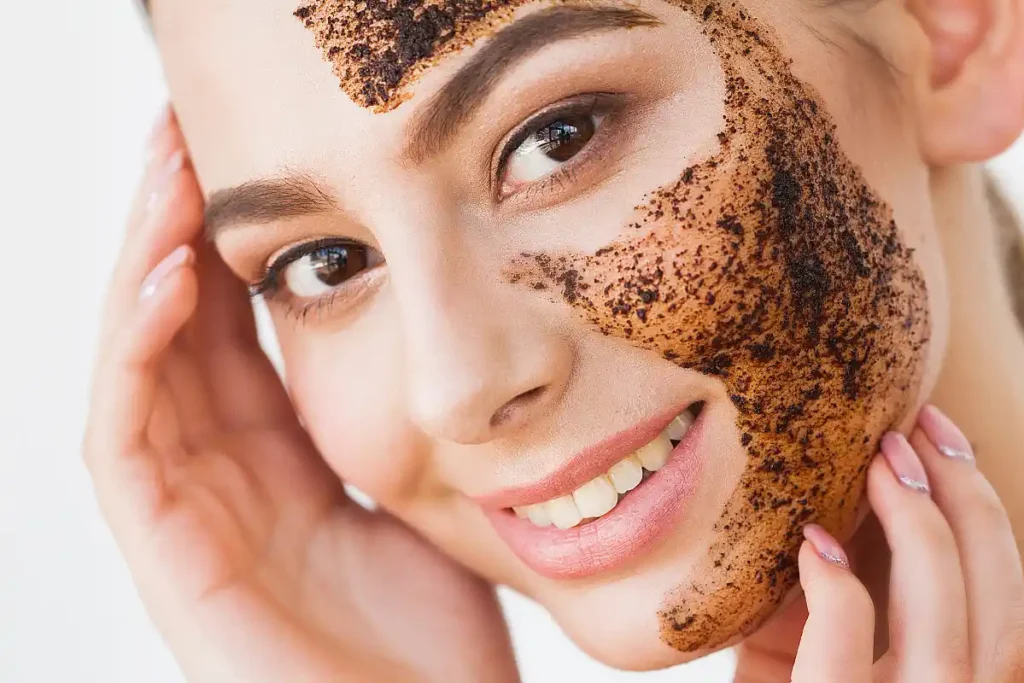 Woman exfoliating her face with a gentle scrub, removing dead skin cells for a smooth and refreshed complexion.