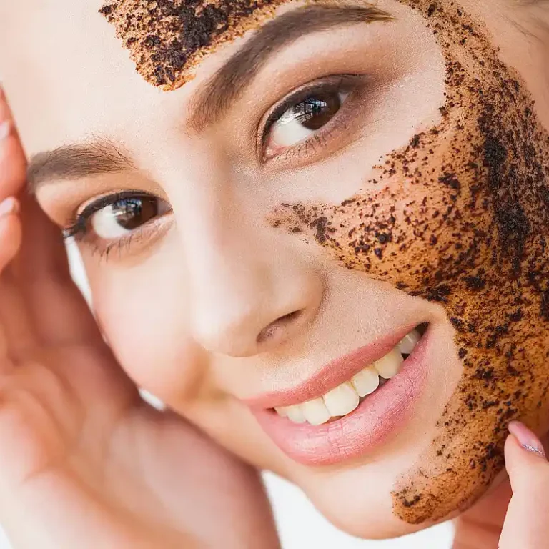 Woman exfoliating her face with a gentle scrub, removing dead skin cells for a smooth and refreshed complexion.