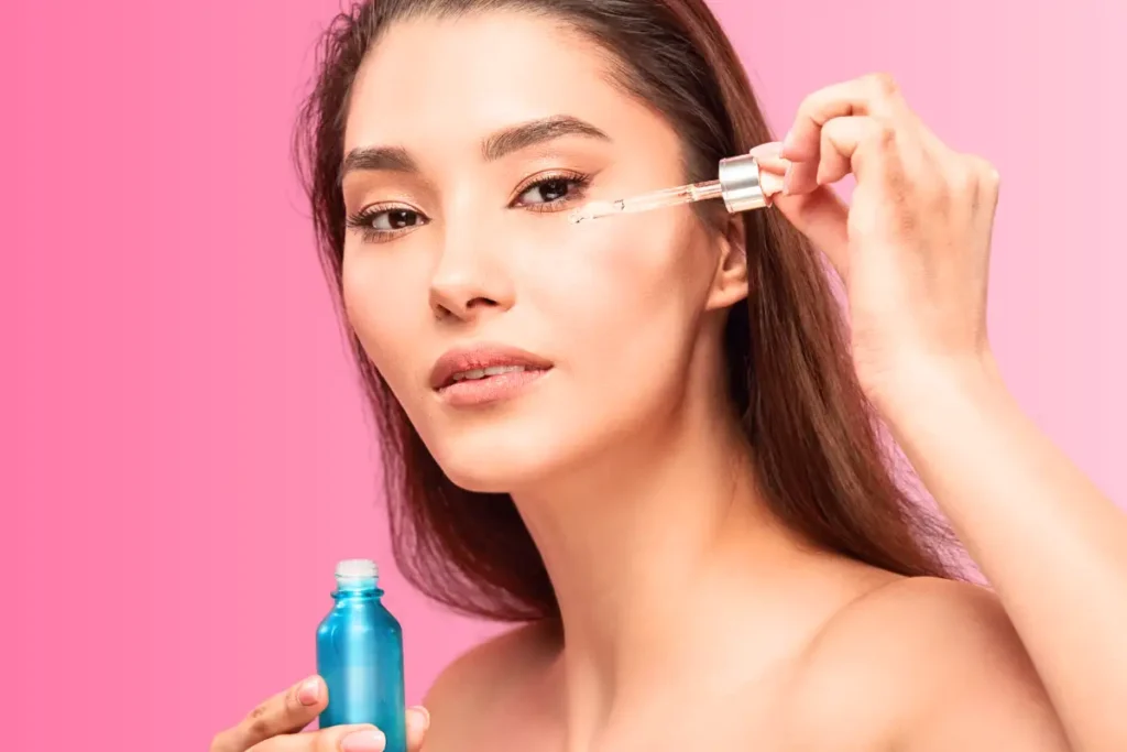 Woman applying retinol as part of her skincare routine.