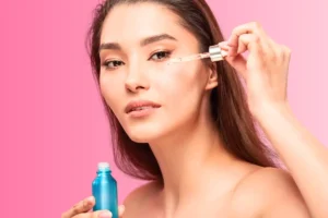 Woman applying retinol as part of her skincare routine.